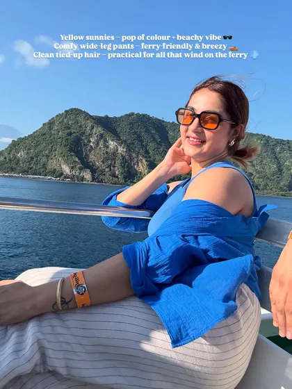 The yellow sunnies add a fun pop of color to this blue and white outfit, creating a cheerful and beachy vibe. The comfy wide-leg pants are ferry-friendly and breezy.