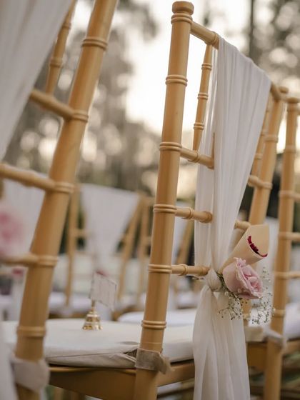 Even the smallest details matter. For this ceremony, we adorned the guest chairs with delicate white drapes and a single pink rose, adding a touch of elegance and tying into the overall pastel floral theme.