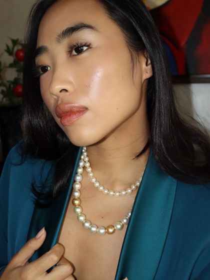 Another beautiful shot of our layered pearl necklace, styled with a modern teal blazer.