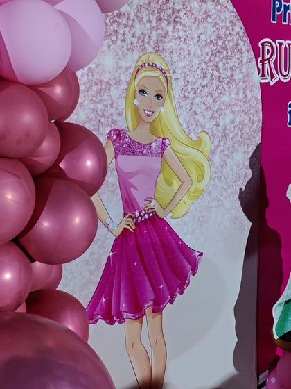 A close-up of a princess-themed backdrop, showing the detailed Barbie and Ariel graphics.