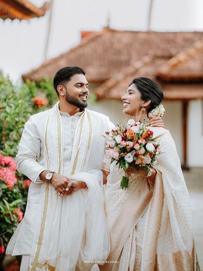 A joyful walking shot of the couple, their smiles and easy chemistry evident as they stroll through a garden.