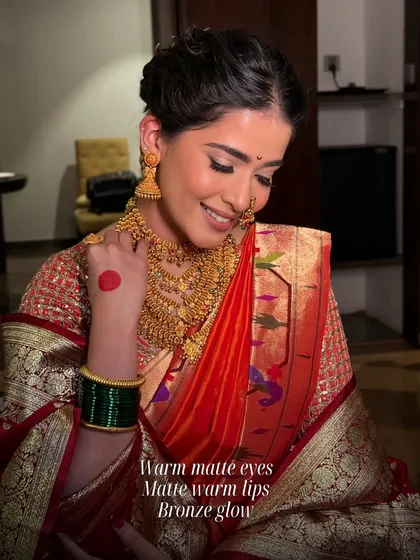 A classic Maharashtrian bridal look. I used warm matte tones on the eyes, warm lips, and a bronze glow to complement the traditional gold jewellery and red Paithani saree.