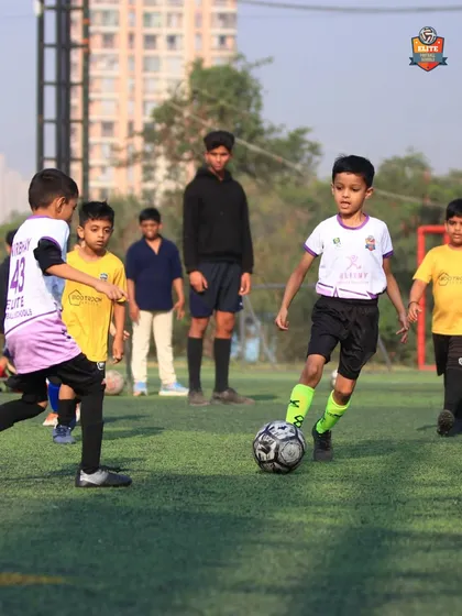 Focus and determination on the face of our U7 player as he moves with the ball.