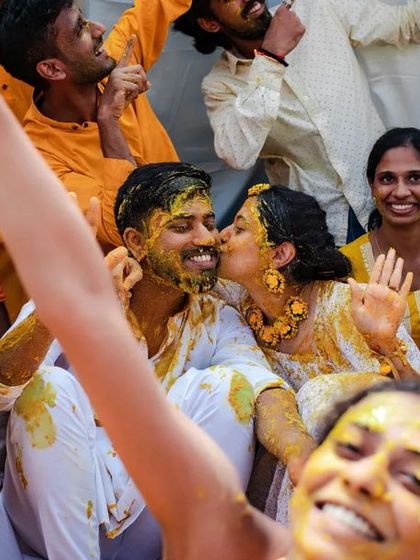 A duplicate of 157, a beautiful candid moment of a kiss during the Haldi celebration.