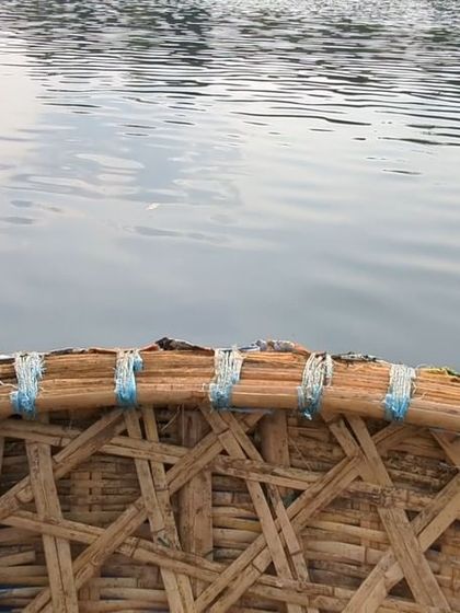 The view from inside a coracle on the Kali River, a traditional round boat used for gentle rides on the water.