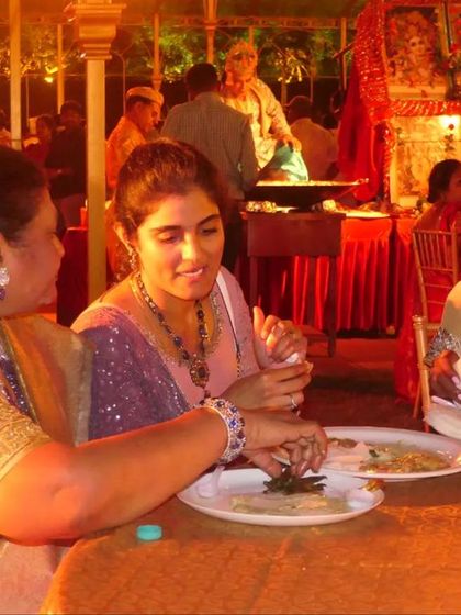 Creating memories around food is what I love to do. This candid moment captures guests enjoying the delicious spread at a beautifully decorated wedding event.