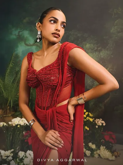 A close-up of the Stardust Saree Set, focusing on the striking red corset blouse, embellished to perfection for a truly diva-like presence.