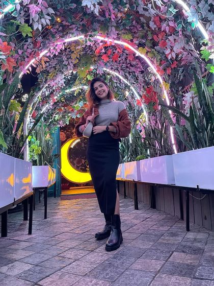 A full-length shot of my winter party outfit. The floral archway was the perfect backdrop.