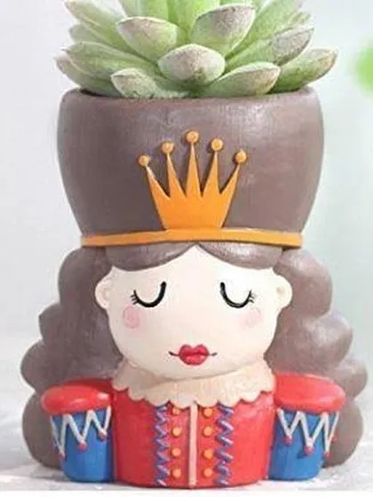 This resin planter is shaped like a queen or princess, complete with a crown. It's a lovely pot for a small succulent, adding a touch of royal charm to your collection.