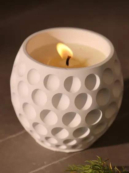 Our white scented candle with a modern golf ball texture. It’s a perfect example of our minimal design philosophy, where simple forms create a powerful impact.