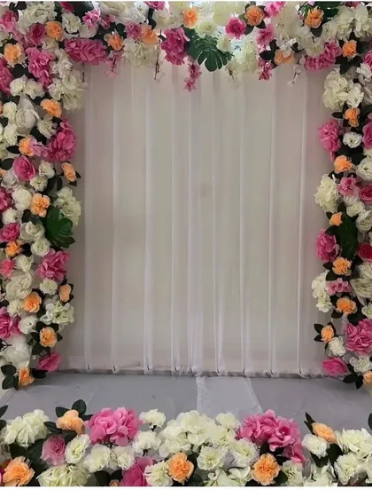 A beautiful floral frame made with pink, white, and peach roses. This versatile backdrop can be used for any festival or as a photo booth for a party.