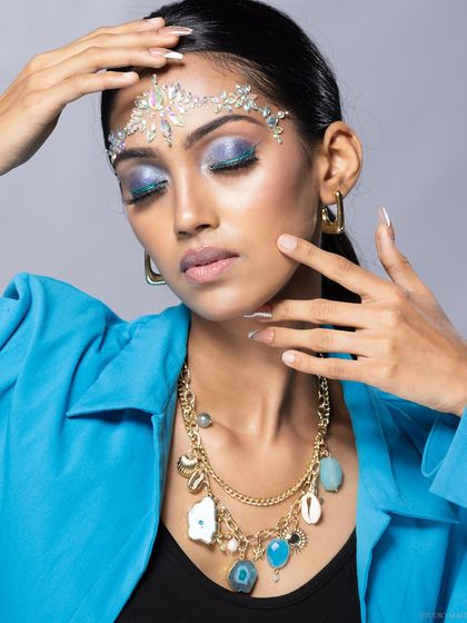 A shot focusing on the interplay between the crystal headpiece, the necklace, and the model's pose.