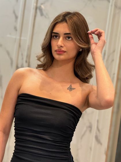 The client posing to show off her new, radiant hair color. The transformation was a success.