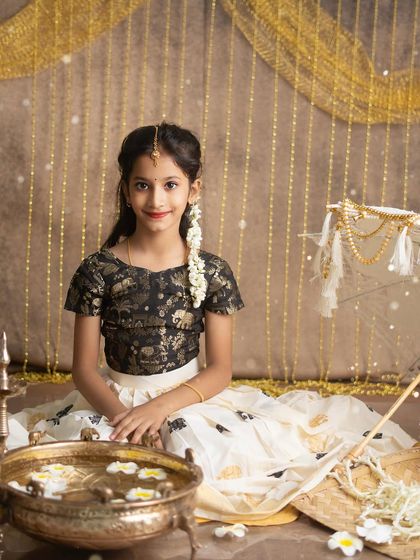 A beautiful solo portrait from our Onam session. The setup, with the nilavilakku and flower petals, is designed to celebrate the spirit of the festival.