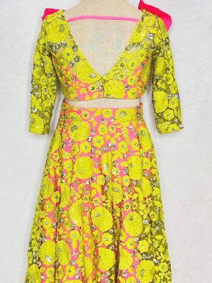 A different angle of the fluorescent lehenga, showing the deep V-back of the choli.