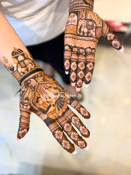A Rakhi special design featuring a portrait of a brother and sister. The other hand includes traditional motifs like elephants and floral patterns.