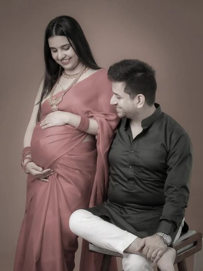 A classic pose with a vintage feel. This maternity portrait in a traditional saree has a timeless quality, capturing the couple's quiet and happy anticipation.