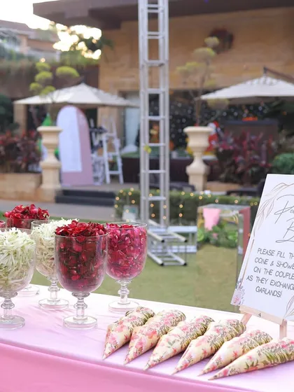 It's the small details that make a big difference. A custom 'Petal Bar' for guests to shower the couple with blessings during the varmala is a thoughtful touch that enhances the experience for everyone and looks beautiful in photos.
