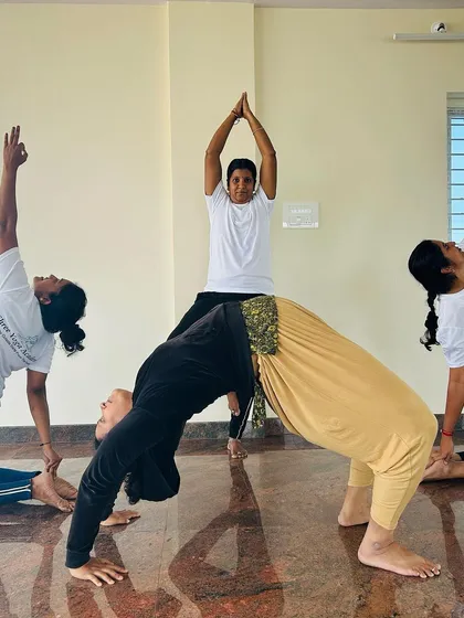 A creative group pose showing the dance of every cell with the music of every breath. This formation combines backbends and standing poses, creating a beautiful picture of harmony.