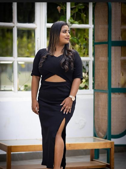 A bold and modern pre-wedding look in a black dress. The makeup is chic and sophisticated, with a smokey eye and a nude lip.