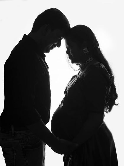 A classic black and white silhouette of a couple. This timeless and romantic pose beautifully captures the intimacy and anticipation of waiting for their baby.