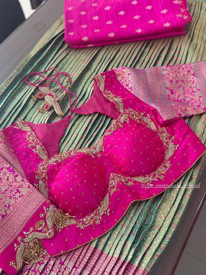 A bright pink blouse with elaborate tassels and zardosi work.