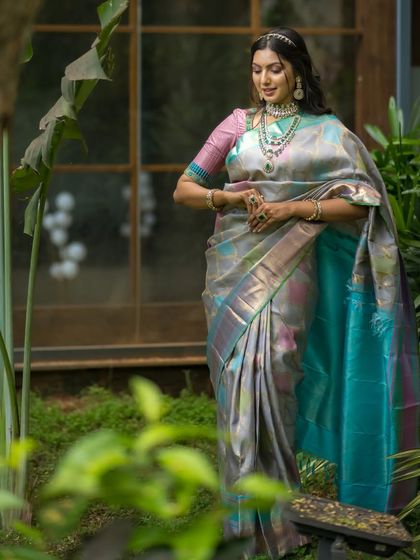 The model in a garden, the natural setting providing a perfect backdrop for the elegant silk saree.
