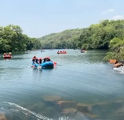 A beautiful panoramic shot of the river at Dandeli, with multiple rafts and kayaks dotting the water, showcasing a typical day at our summer camp.