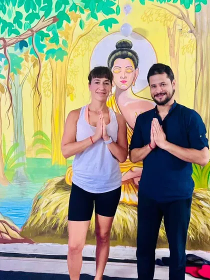 Sharing a moment of gratitude with a student. The traditional 'Namaste' gesture signifies that the light in me honors the light in you.