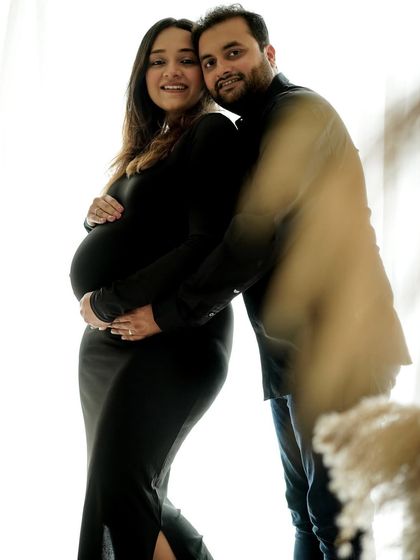 A candid and happy moment, proving that even camera-shy partners can relax and enjoy the session.