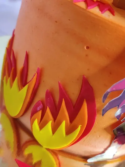 Detail shot of the layered, edible flame decorations that give this Demon Slayer cake its dynamic and fiery look.