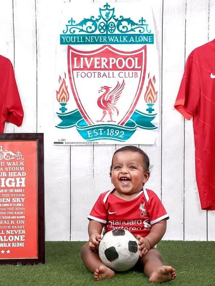 Another great photo of our little Liverpool supporter, capturing his excitement and love for the game.