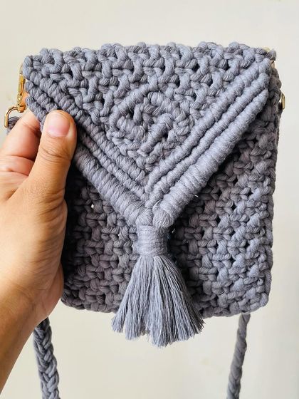 This grey mobile sling bag is so practical and stylish. The V-flap design has a cute tassel, and it's just the right size to carry your phone and cards.