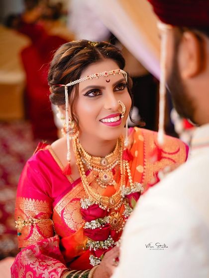 A beautiful close-up of the bride looking lovingly at her groom during the ceremony. The focus is on her expressive eyes and happy smile.