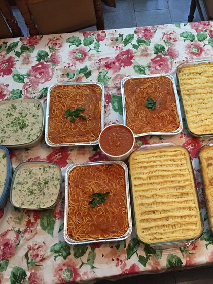 A full view of a continental catering order laid out on the table. You can see the different main courses and sides, all packed in convenient trays for easy serving at your event.