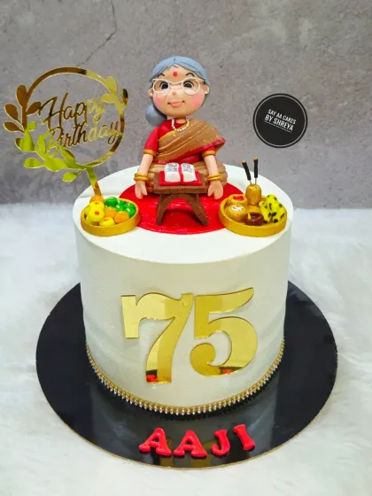 A truly special cake to celebrate 75 graceful years. I created a custom figurine of the 'Aaji' (grandmother) reading her holy books, surrounded by edible prasad and puja items, making it a deeply personal and respectful tribute.