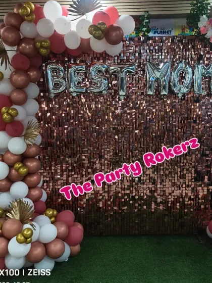 Another view of the Mother's Day backdrop, showing the beautiful combination of the shimmer wall, balloons, and artificial flowers.