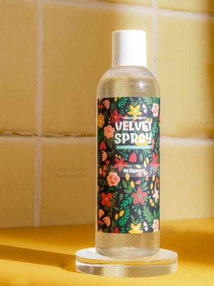 A slightly different angle of the body spray on a tiled background. Providing multiple similar shots gives the client options for different marketing uses.