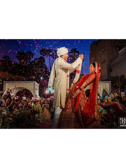 When Deeksha and Prakhar met at the mandap, the night sky lit up with pyrotechnics. This award-winning photo captures the epic scale and electric atmosphere of their varmala ceremony.