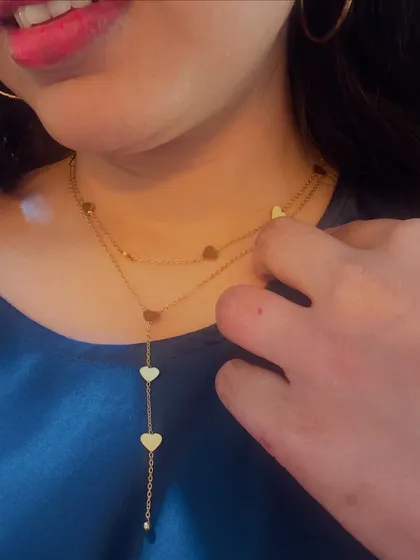 A detailed look at a layered heart necklace from Palmonas, demonstrating how it sits beautifully and adds a touch of romance to any outfit.