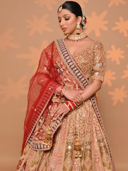 A beautiful bridal portrait featuring our golden multi-color lehenga. The outfit's warm tones and intricate patterns are perfect for traditional Indian wedding ceremonies.