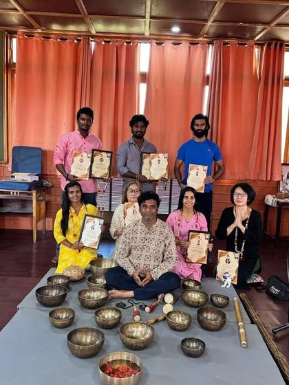 A group of graduates from the Singing Bowl and Sound Healing course, holding their certificates with pride.