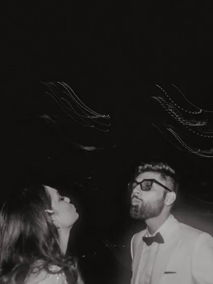 An artistic, motion-blur shot of the couple against the night lights, capturing the energy and style of their engagement night.