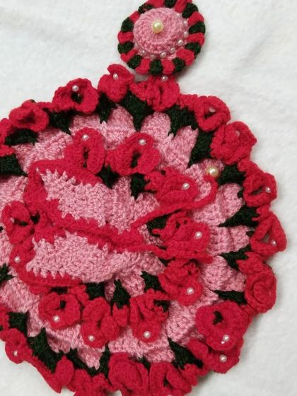 The complete red and pink floral poshak set, laid out to show the dress and its matching cap. This is a wonderful winter outfit for Kanha Ji.