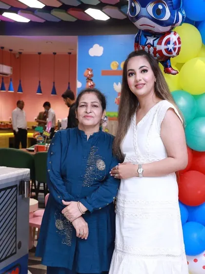 A mother and daughter posing by the colorful balloon decor. Every corner of Wobble World is a great spot for a photo.