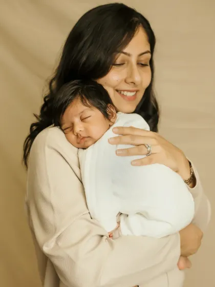 A mother's love captured in a single frame. The way she holds her sleeping newborn is so gentle and full of warmth.
