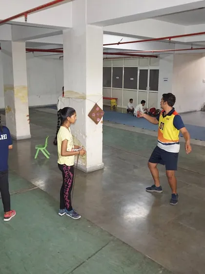 A coach instructs students during a target practice session. We use various training aids to make learning fundamental skills engaging and effective.