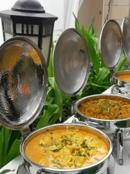 A glimpse of our classic Indian buffet offerings. We serve a variety of rich and flavourful curries and vegetable preparations, presented in elegant hammered-metal chafing dishes that keep the food warm and inviting.