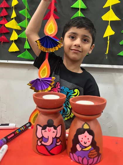 This young man is very pleased with his finished Diwali decorations.