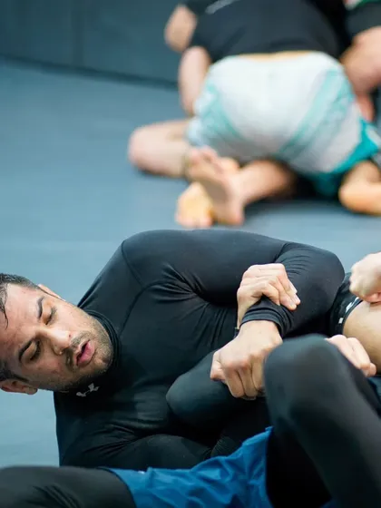 The intensity of a live roll is where you truly learn. This student is working to escape a difficult position, building the composure and technical skill needed for high-pressure situations.